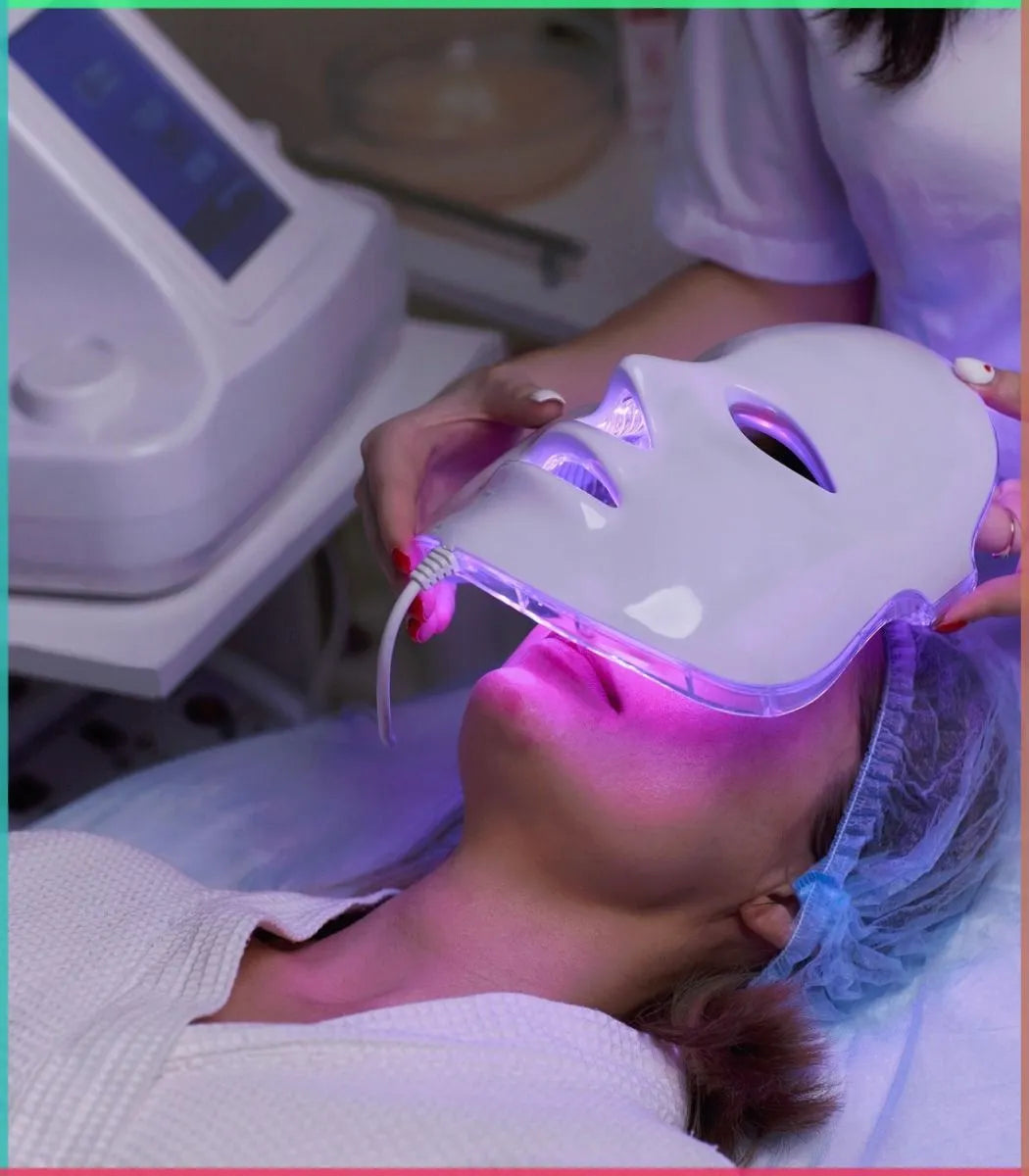 Person receiving LED face mask treatment in a clinical setting